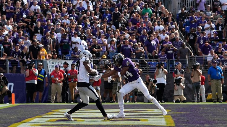 Las Vegas Raiders wide receiver Davante Adams, left, catches a...