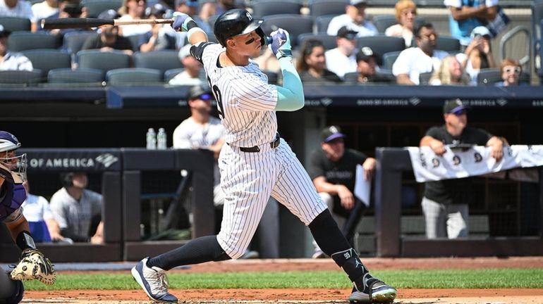 New York Yankees’ Aaron Judge follows through on his solo...