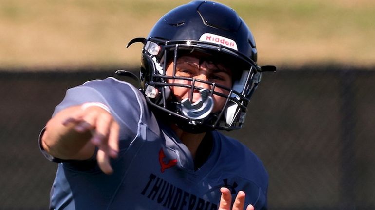 Half Hollow Hills East QB Jordan Heyman gets the pass...