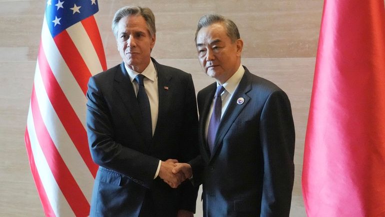 U.S. Secretary of State Antony Blinken, left, shakes hands with...