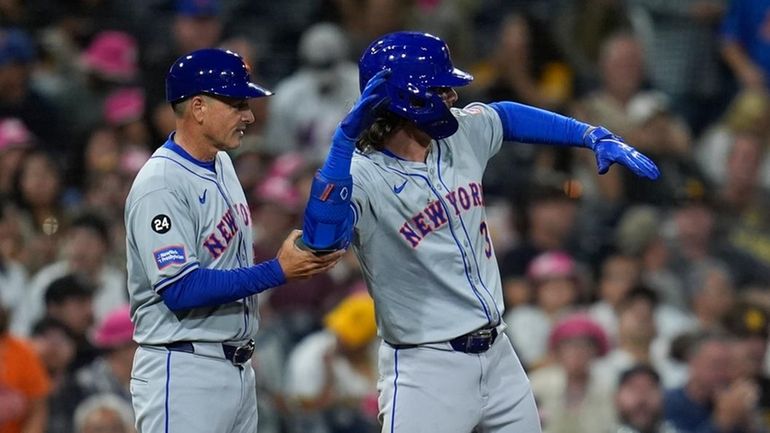 The Mets' Jesse Winker celebrates after hitting an RBI double...