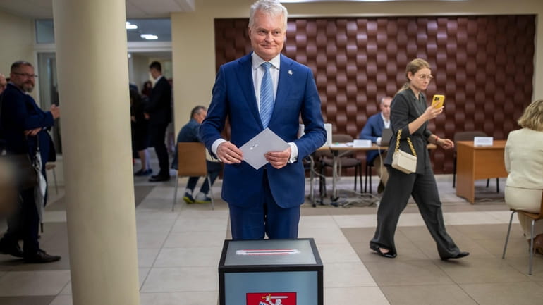 Lithuania's President Gitanas Nauseda, a presidential candidate, prepares to cast...