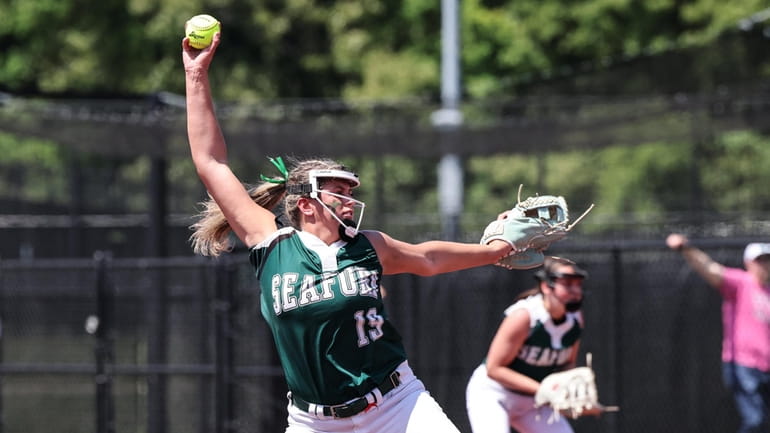 Seaford starting pitcher Skyler Secondino windmills her delivery during game...