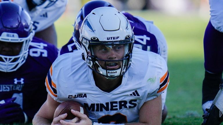 UTEP quarterback Gavin Hardison is on the ground after getting...