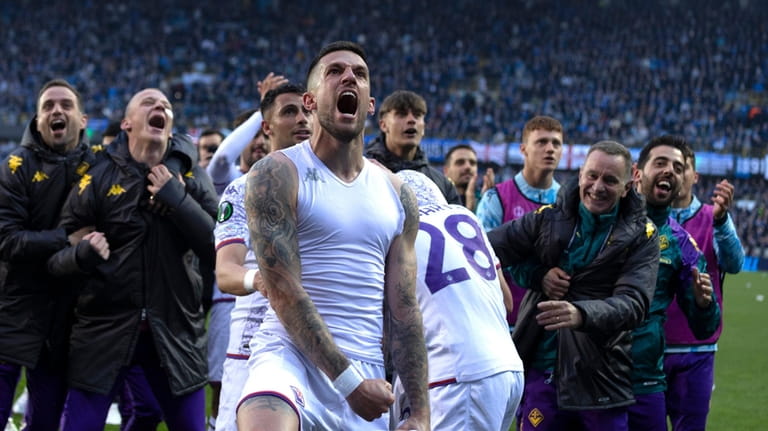 Fiorentina's players celebrate after the Europa Conference League semi-final second...