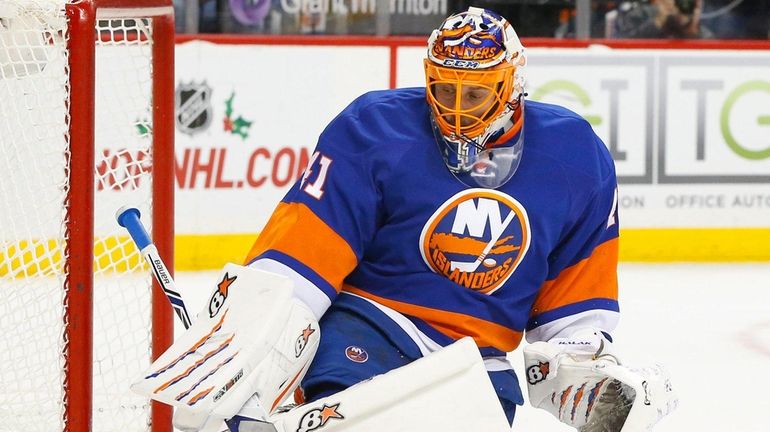 Jaroslav Halak of the New York Islanders makes a save...