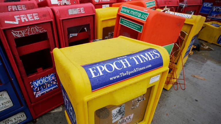 Plastic newspaper racks for The Epoch Times, The Village Voice...