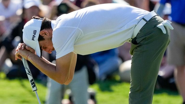 Chile's Joaquin Niemann reacts after just missing an eagle putt...