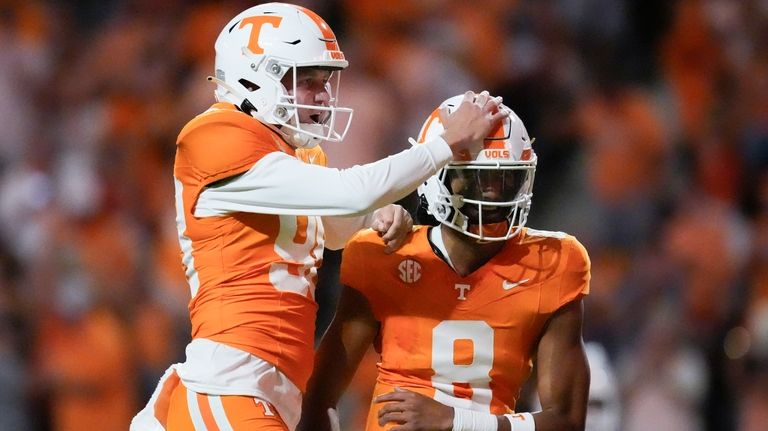 Tennessee punter Jackson Ross, left, congratulates quarterback Nico Iamaleava (8)...