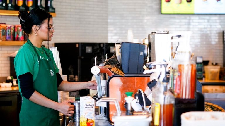 File - Nicole Lipa prepares a drink at a Starbucks...