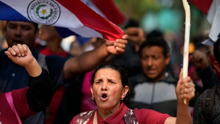 Anti-government protesters march during an opposition rally, marking a year...