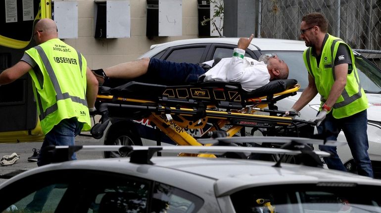 Ambulance staff take a man from outside a mosque in...