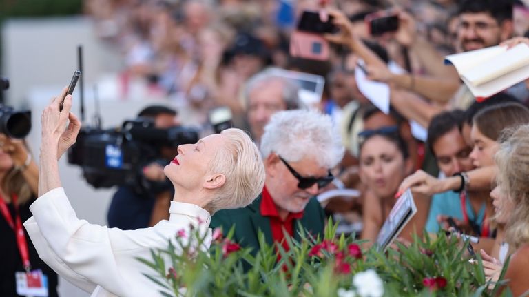 Tilda Swinton takes a selfie upon arrival for the premiere...