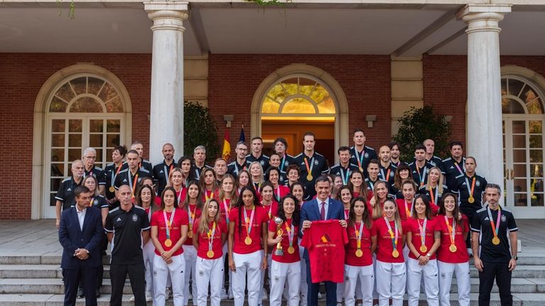 Spain's acting Prime Minister Pedro Sanchez stands with Spain's Women's...