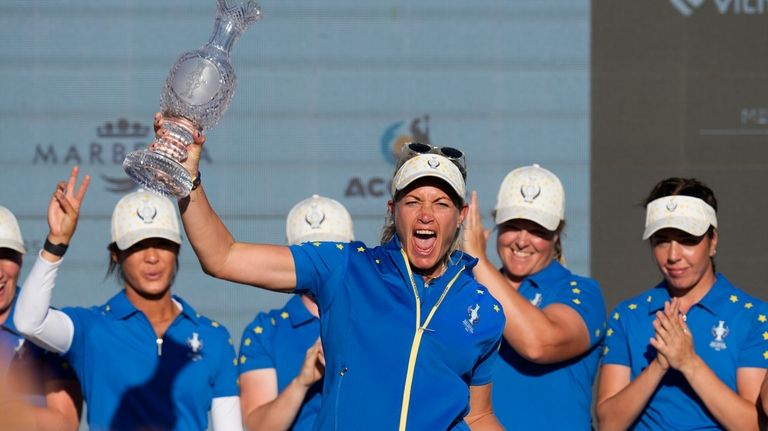 Europe's Team Captain Suzann Pettersen lifts the trophy after wining...