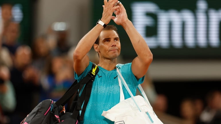 Spain's Rafael Nadal waves as he leaves the court after...