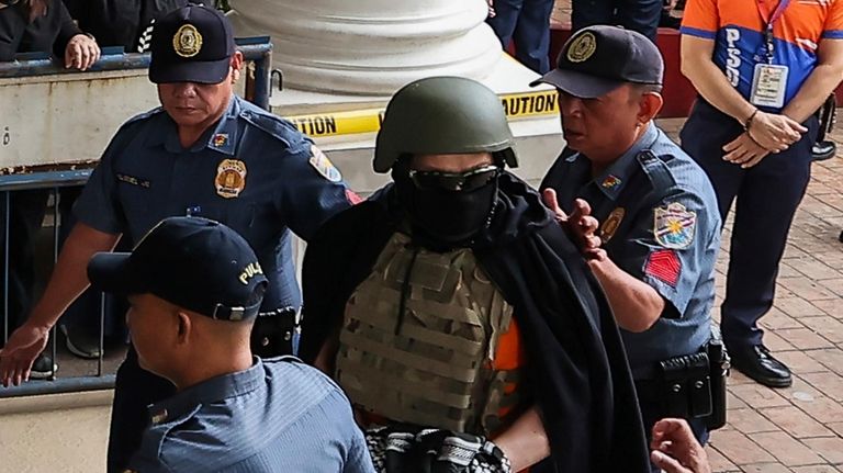 Apollo Carreon Quiboloy, wearing a helmet and flak jacket, a...