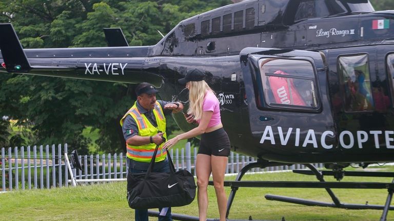 Fanny Stollar, of Hungary, steps off a helicopter for her...