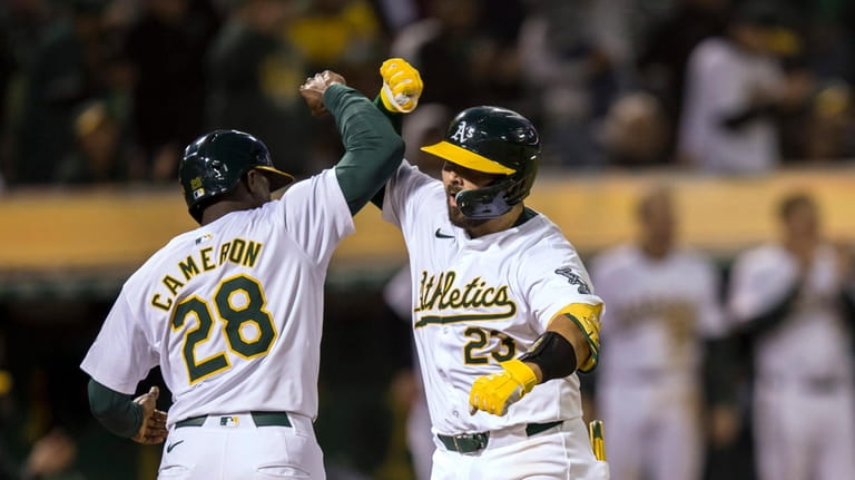 Oakland Athletics' Shea Langeliers is congratulated by Daz Cameron (28)...