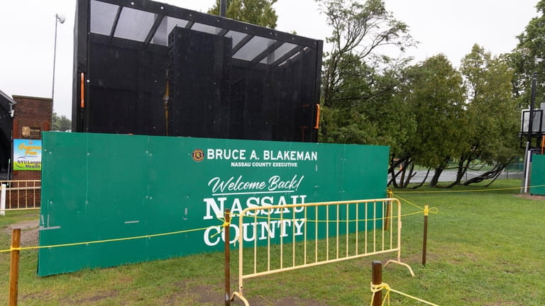 Signs display the name of County Executive Bruce Blakeman at...