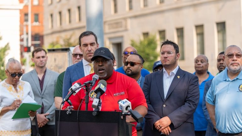 Baltimore City Councilmember Antonio Glover, center, speaks at a news...