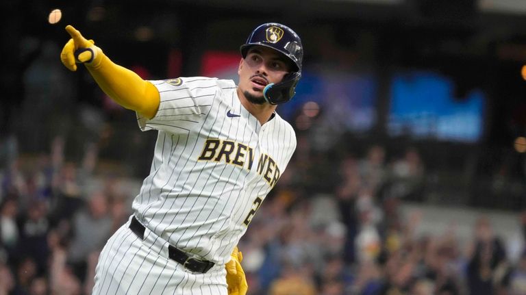 Milwaukee Brewers' Willy Adames (27) celebrates hitting a home run...