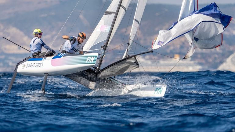 Finland's Sinem Kurtbay and Akseli Keskinen, compete in a mixed...