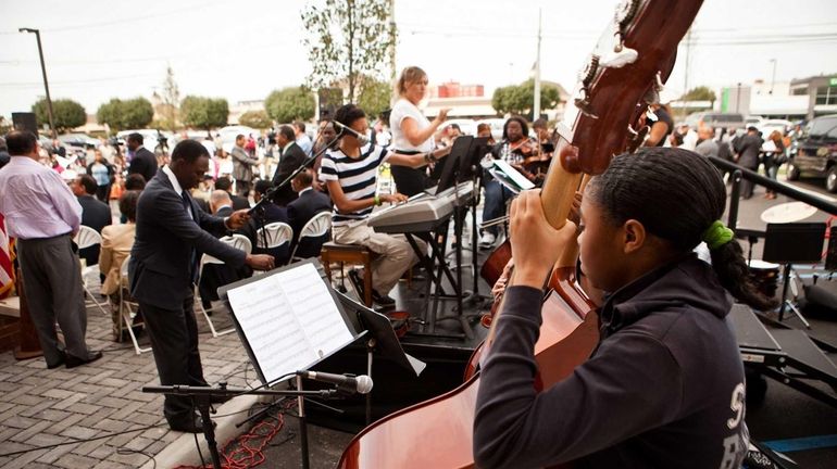 Hempstead High School students play music for the ribbon-cutting ceremony...