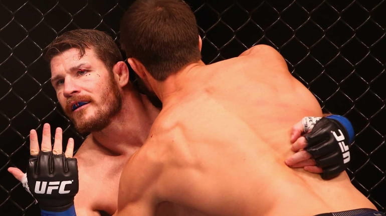Michael Bisping appeals to the referee after being cut above...