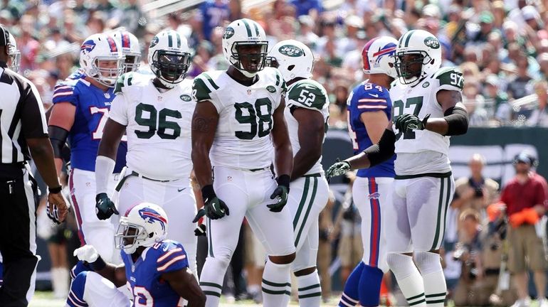 Quinton Coples celebrates after he tackled C.J. Spiller of the...