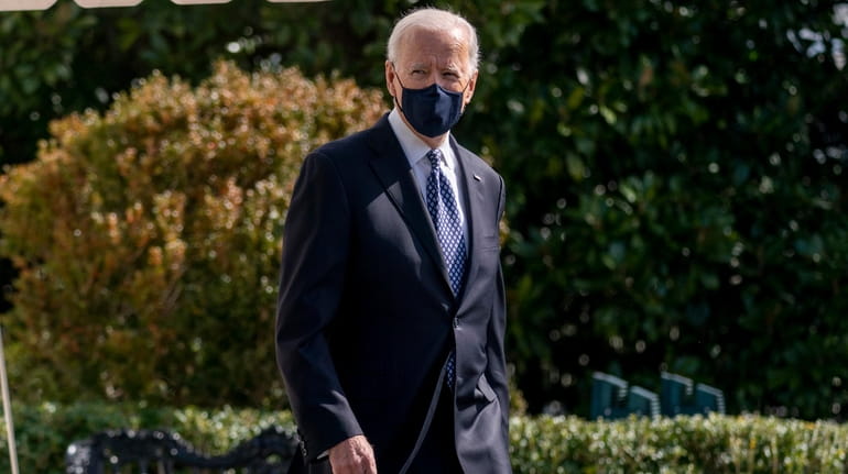President Joe Biden walks to board Marine One on the...