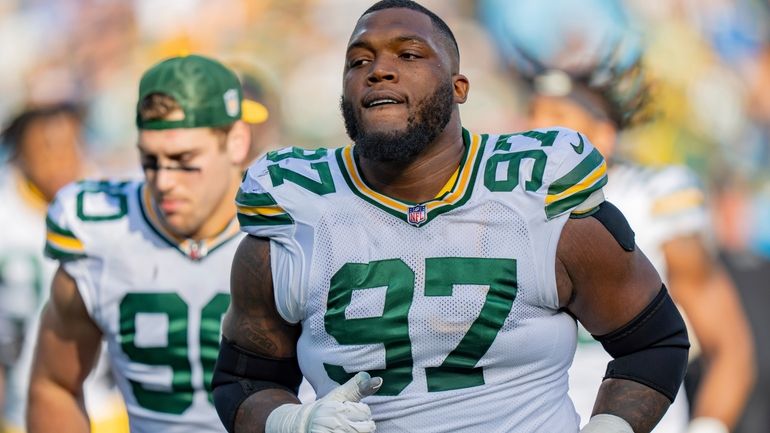 Green Bay Packers defensive tackle Kenny Clark (97) looks on...