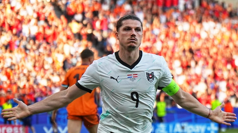 Austria's Marcel Sabitzer celebrates after scoring his side's third goal...