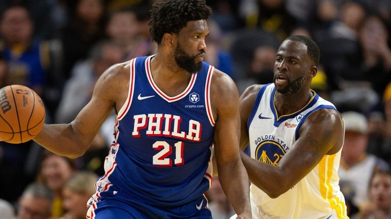 Philadelphia 76ers center Joel Embiid (21) looks to pass around...