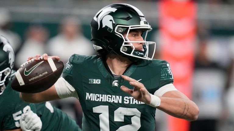 Michigan State quarterback Katin Houser throws during the first half...