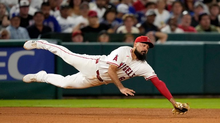 Los Angeles Angels third baseman Anthony Rendon can't get to...