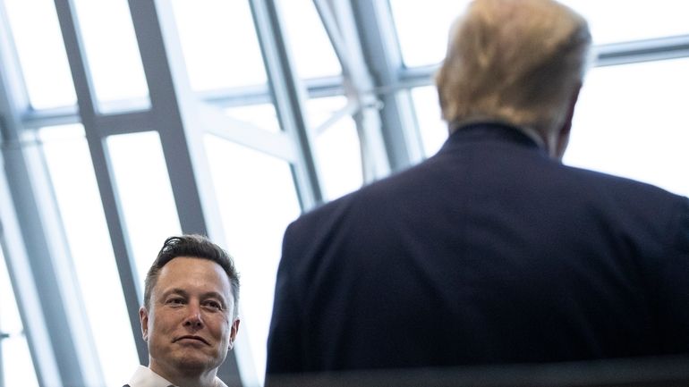 Tesla and SpaceX CEO Elon Musk talks with President Donald...