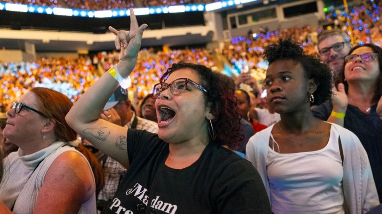 Monique LaFonta, of Milwaukee, dances while watching the roll call...