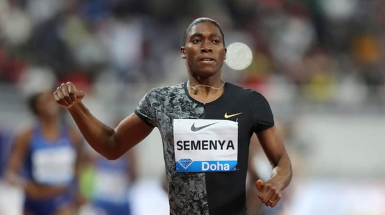 South Africa's Caster Semenya crosses the line to win gold...