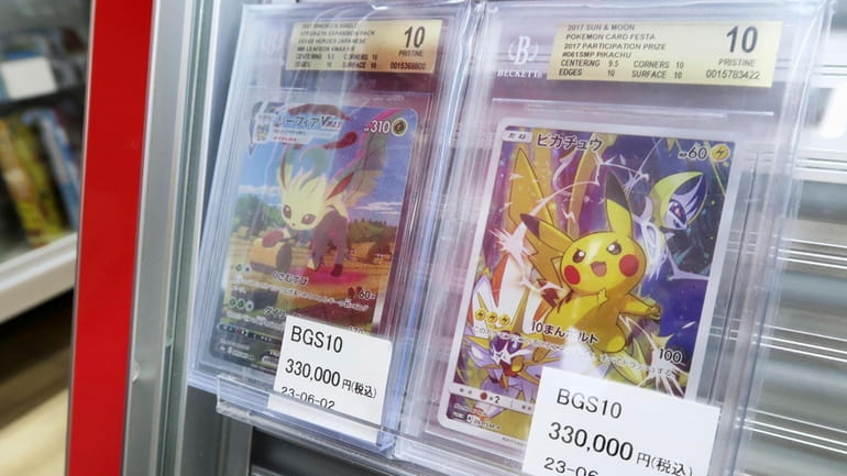 Pokemon cards are on display for sale at a shop...