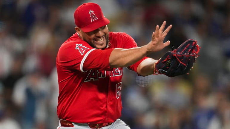 Los Angeles Angels relief pitcher Carlos Estévez celebrates after a...