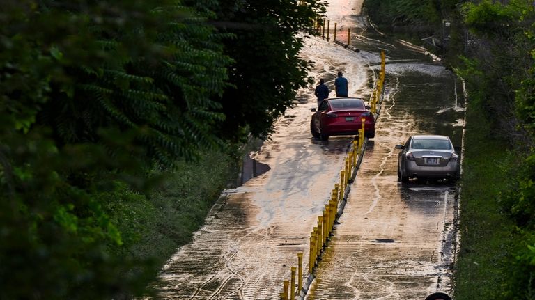 Cars remain stranded on Bayview Avenue as water recedes following...