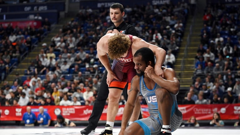Trent Hidlay, left, consoles Mark Hall, right, after an 86-kilogram...