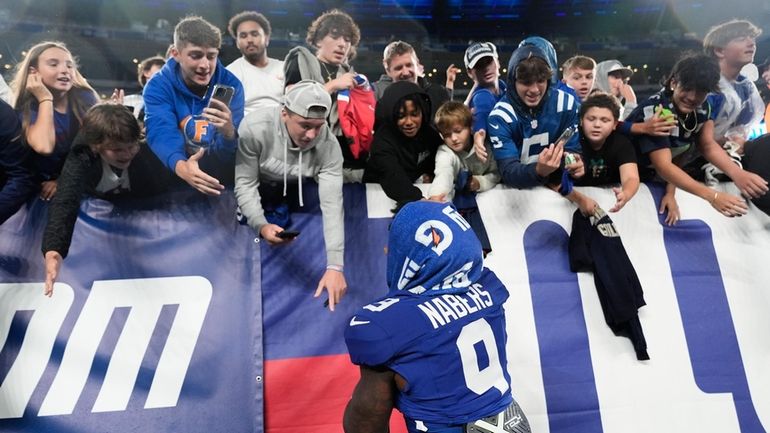 Giants wide receiver Malik Nabers greets fans after playing against...