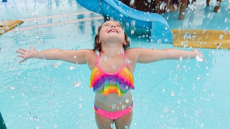 Sophia Giannini, 8, of Deer Park, plays in the water...