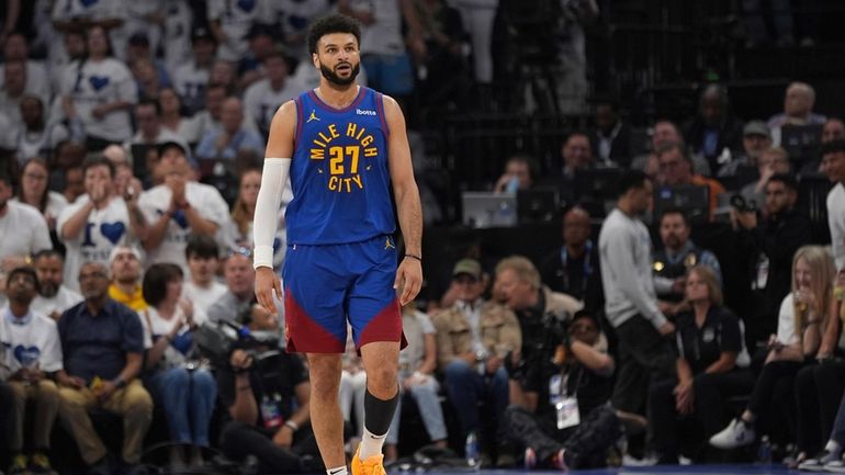 Denver Nuggets guard Jamal Murray walks on the court during...