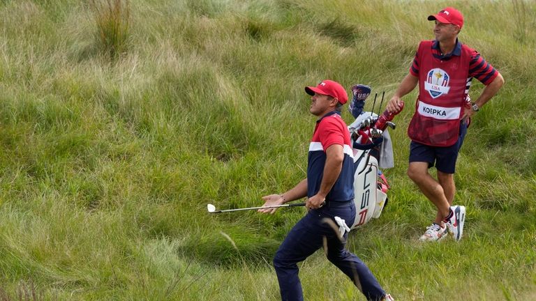 Team USA's Brooks Koepka hits from the rough on the...