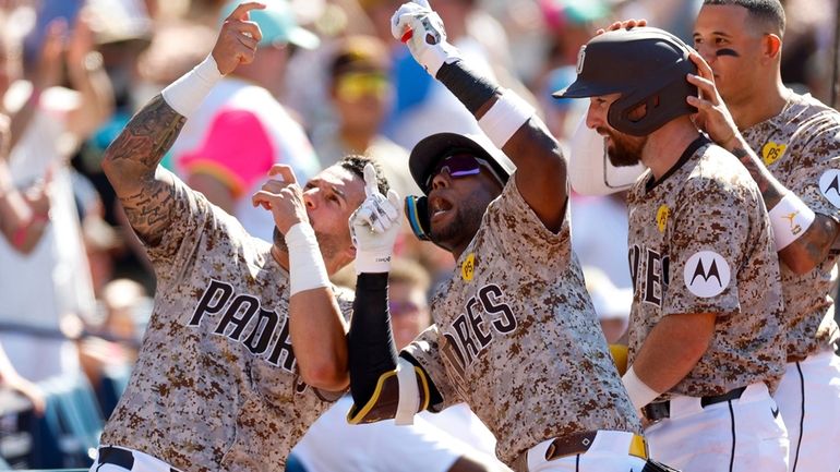 San Diego Padres' Jurickson Profar, second left, celebrates with David...