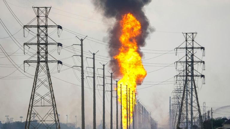 A pipeline with a giant plume of fire burns Monday,...