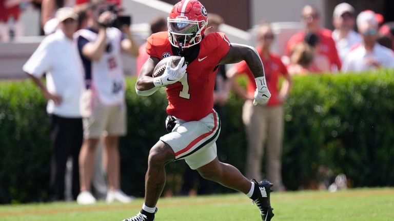 Georgia running back Trevor Etienne (1) runs for a big...